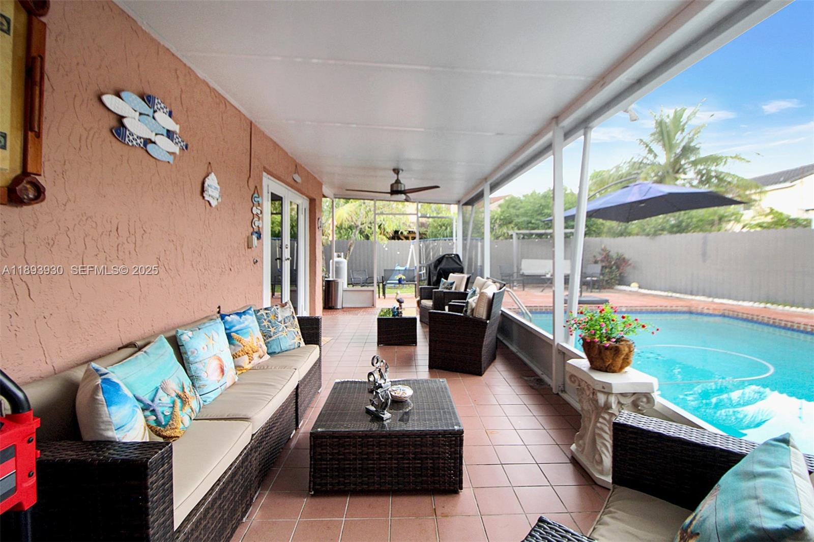 13246 Southwest 9th Terrace Miami, FL 33184 - Photo 19 of 34 a living room with patio furniture and a potted plants