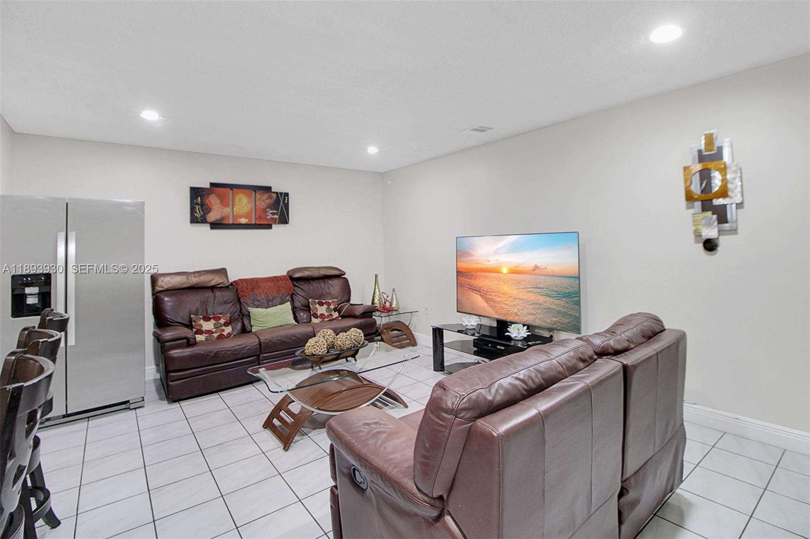 13246 Southwest 9th Terrace Miami, FL 33184 - Photo 9 of 34 a living room with furniture and a flat screen tv