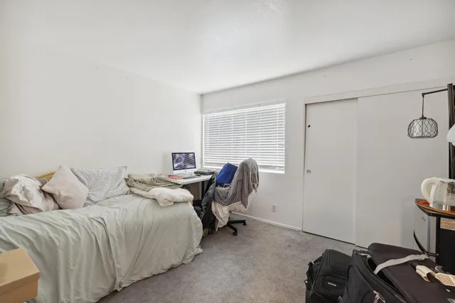 a bedroom with a bed and a desk