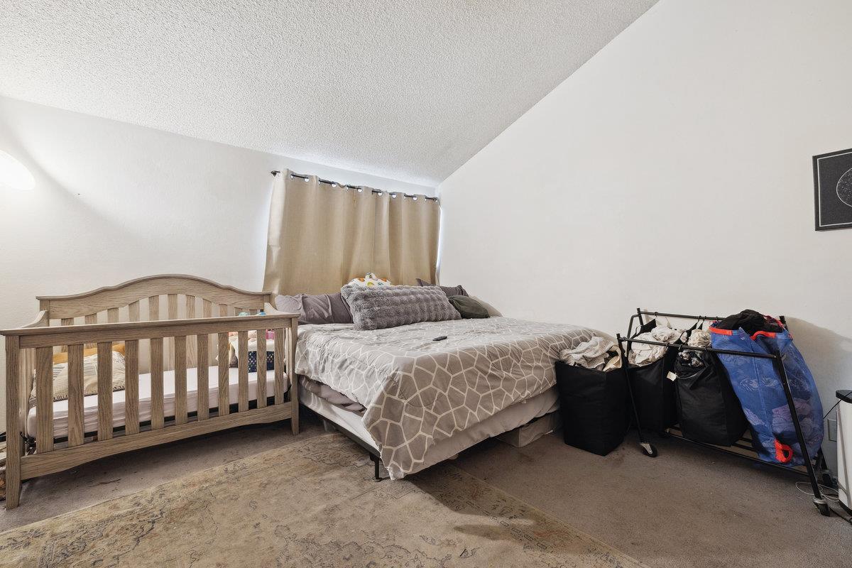 415 West Gutierrez Street, Unit 11 Santa Barbara, CA 93101 - Photo 12 of 16 a bedroom with a bed and a baby crib
