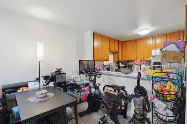a very nice looking dining room with kitchen island furniture a stove a sink and a large window