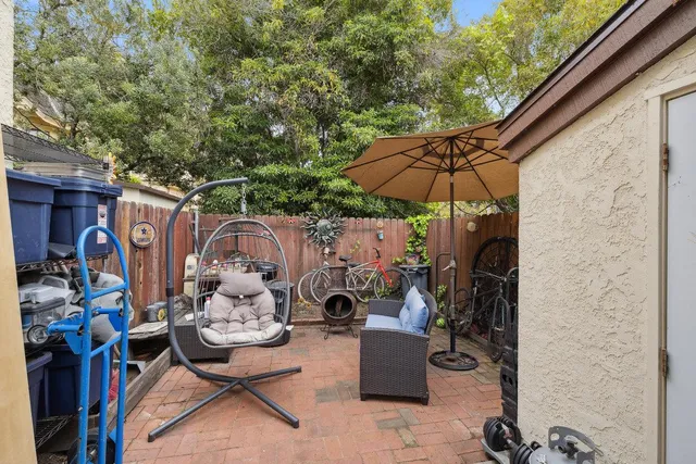 an outdoor space with patio and white umbrellas
