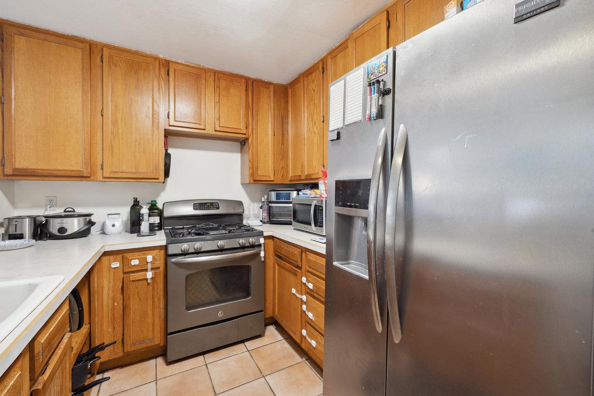 415 West Gutierrez Street, Unit 11 Santa Barbara, CA 93101 - Photo 7 of 16 a kitchen with stainless steel appliances granite countertop a refrigerator a stove a sink and dishwasher