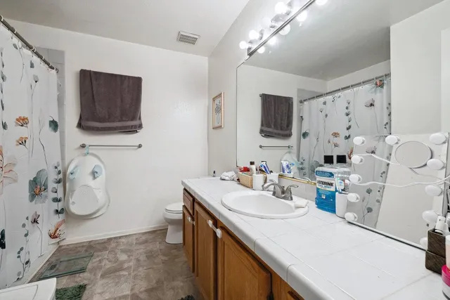 a bathroom with a sink double vanity and a mirror