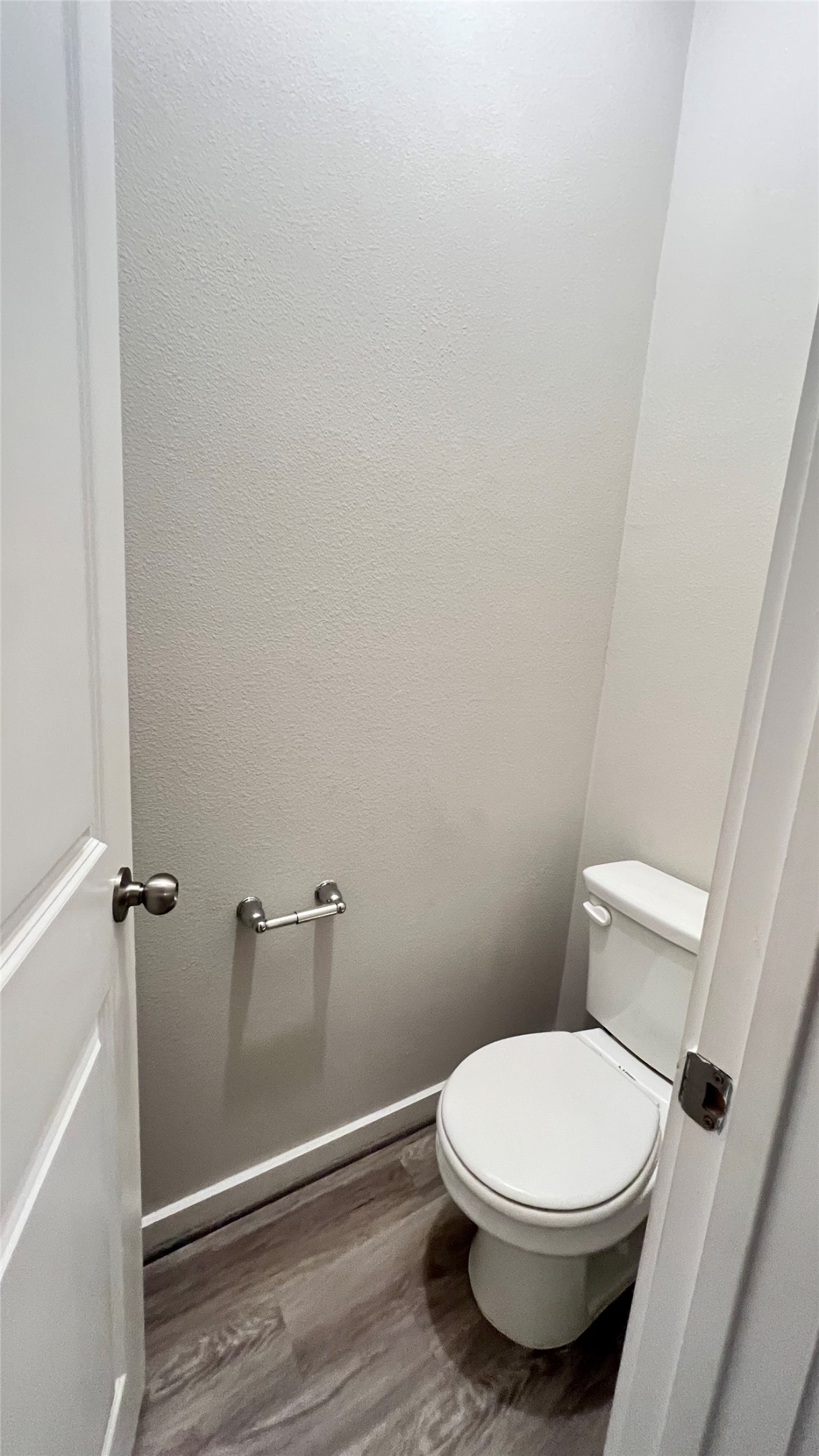 600 D Knopper Street Pflugerville, TX 78660 - Photo 13 of 24 a white toilet sitting next to a wooden floor