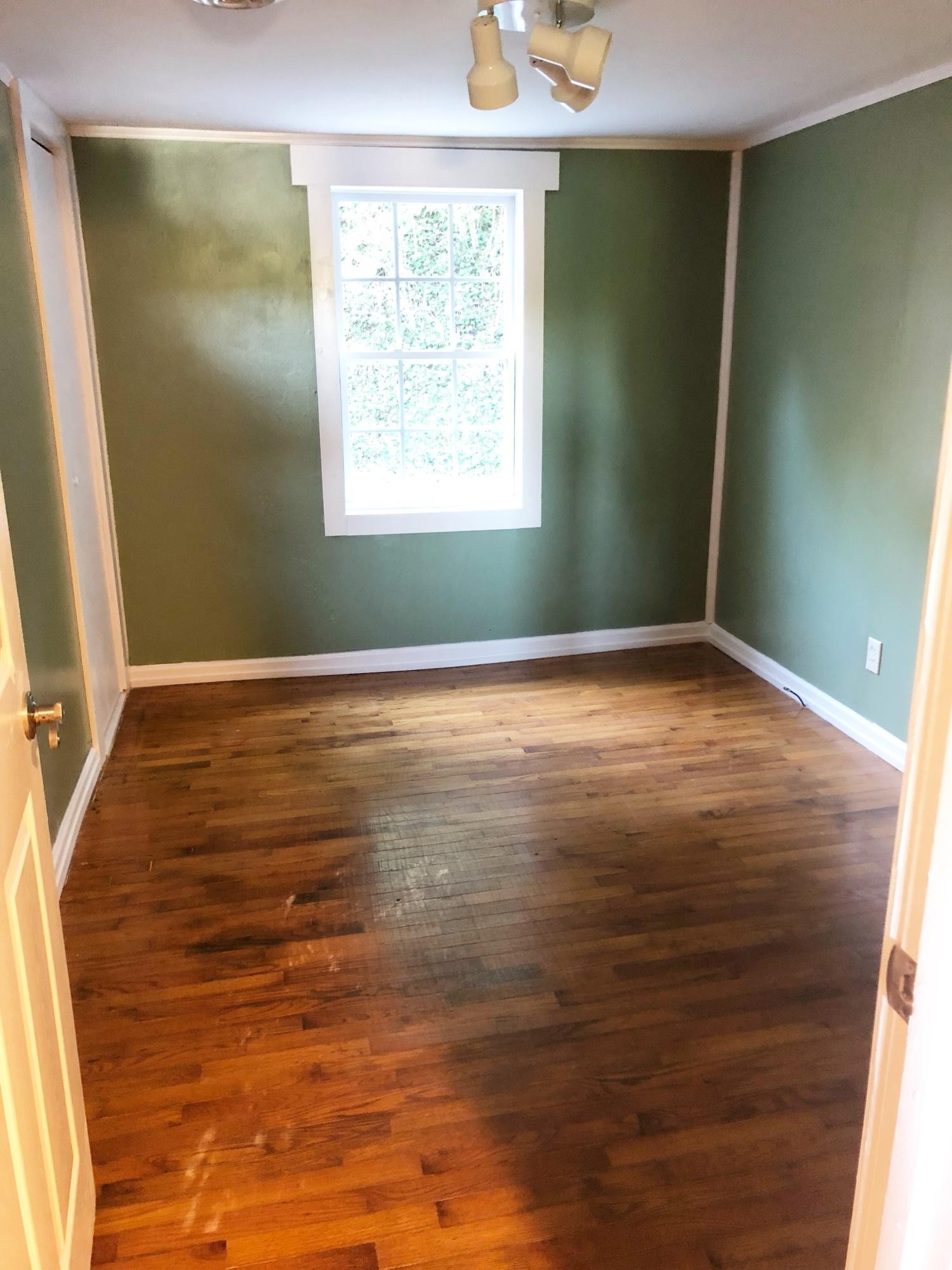 304 Lee Road Clinton, TN 37716 - Photo 16 of 21 a view of an empty room with window and hardwood floor
