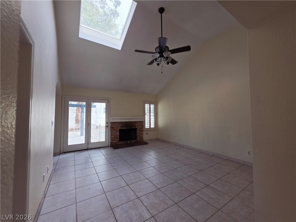 2920 Setting Sun Street Las Vegas, NV 89117 - Photo 19 of 43 This bright living space features a vaulted ceiling and a classic brick fireplace.