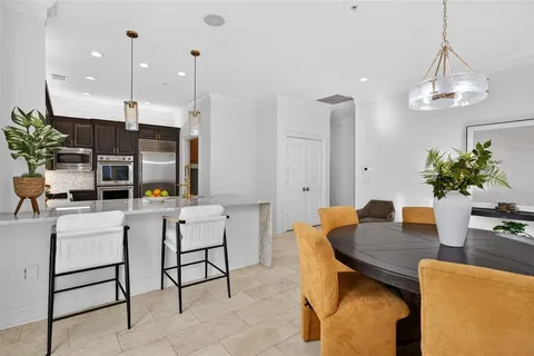a dining room with furniture and a chandelier