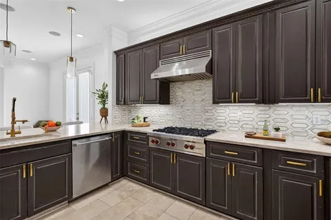 a kitchen with stainless steel appliances a sink stove and cabinets