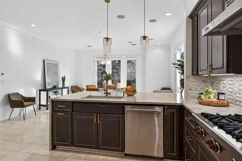 a kitchen with stainless steel appliances granite countertop a stove a sink and a refrigerator