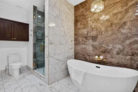 a view of a kitchen with a refrigerator and cabinets