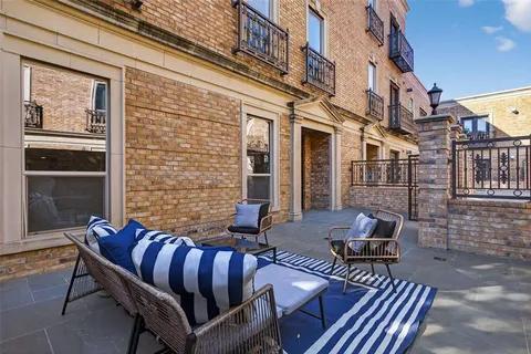 a view of a patio with couple of chairs and a couch