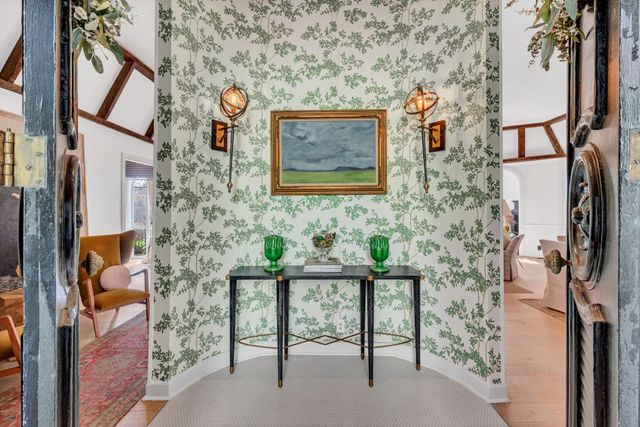 a brick building with a bench and a sign on it