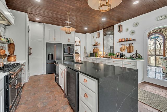 a kitchen with stainless steel appliances granite countertop a sink and cabinets