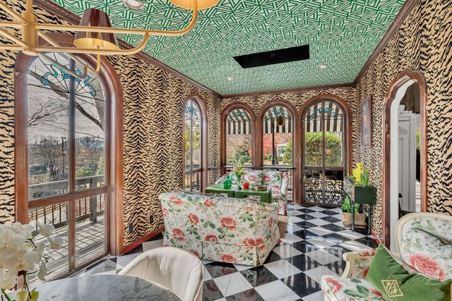 a balcony with furniture and a potted plant