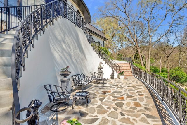 a view of a patio with table and chairs and potted plants with wooden floor