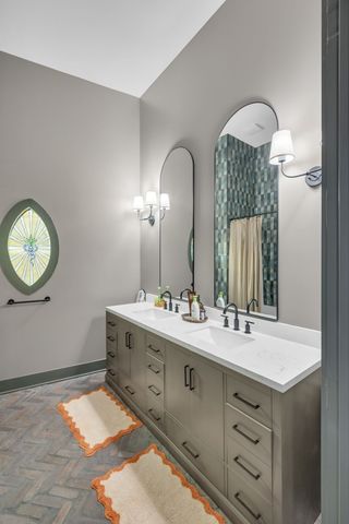 a backyard view with a table and chairs under an umbrella
