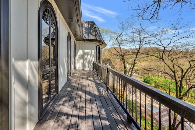 a view of a balcony with wooden floor and outdoor seating