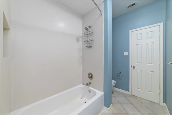 a bathroom with a bathtub and shower