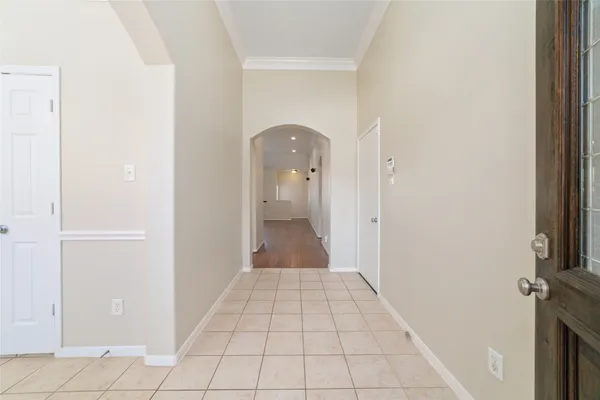 a view of a hallway view with wooden floor and a bathroom