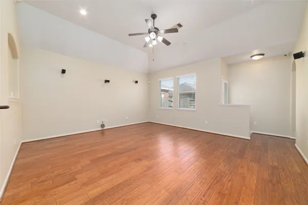 wooden floor in an empty room with a window