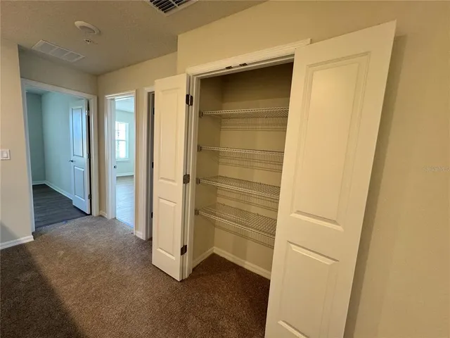 an empty room with wooden floor and closet