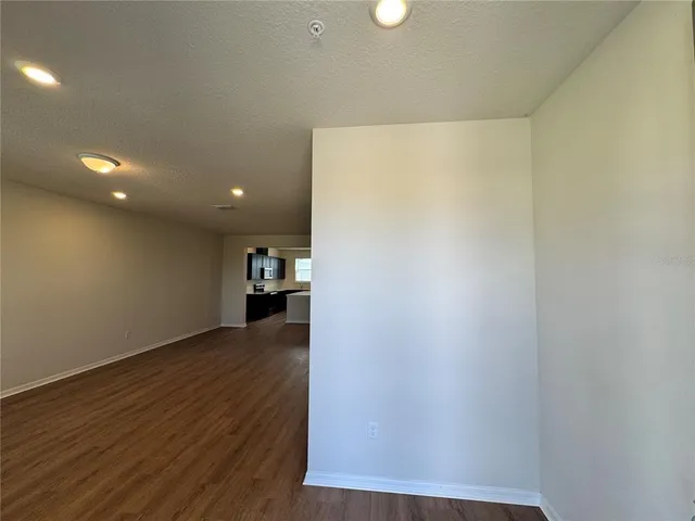 a view of a kitchen with wooden floor and a sink