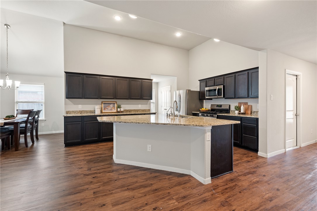2018 Eagle View Drive Navasota, TX 77868 - Photo 5 of 28 a kitchen with kitchen island granite countertop stainless steel appliances and wooden cabinets