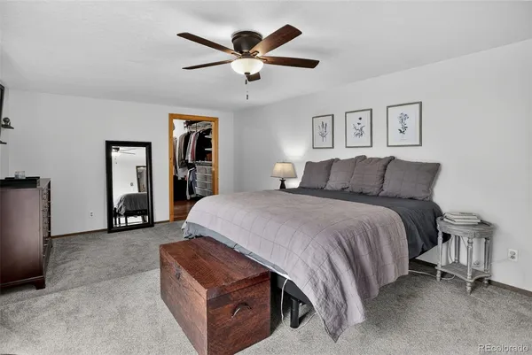 a spacious bedroom with a bed and a large window