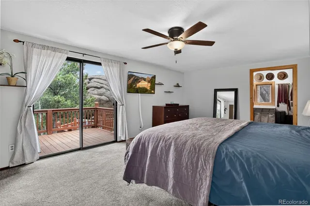 a spacious bedroom with a bed and a chandelier