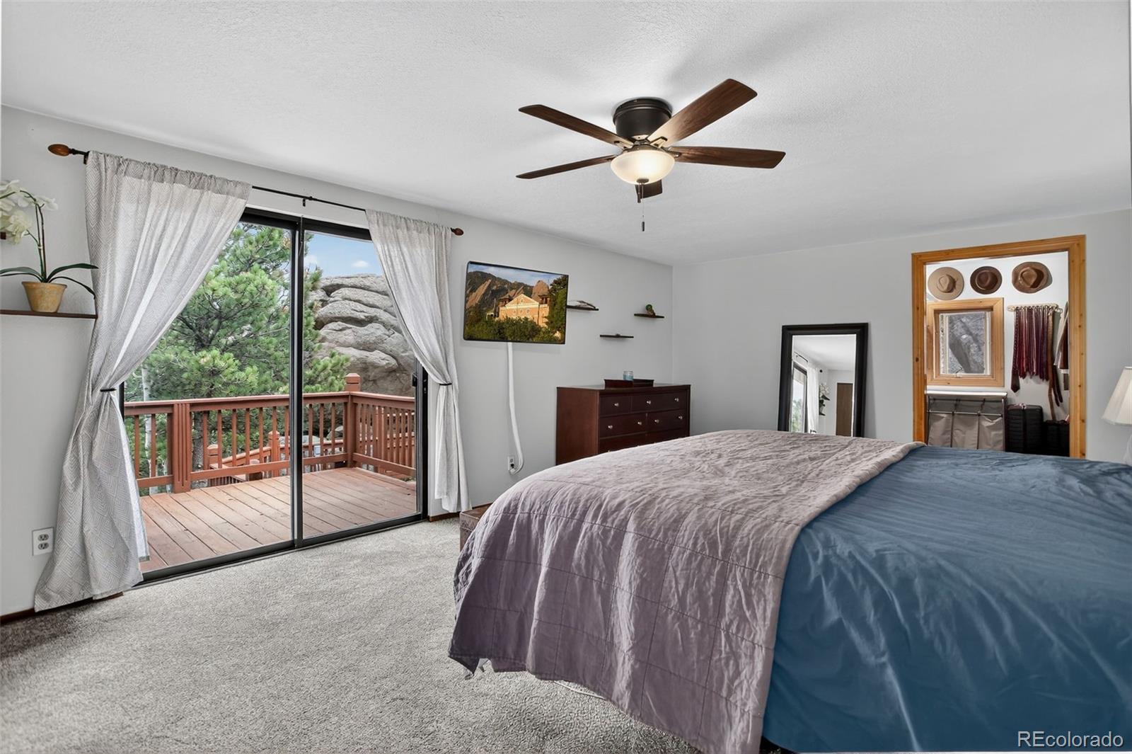 31911 Warrens Road Golden, CO 80403 - Photo 14 of 42 a spacious bedroom with a bed and a large window