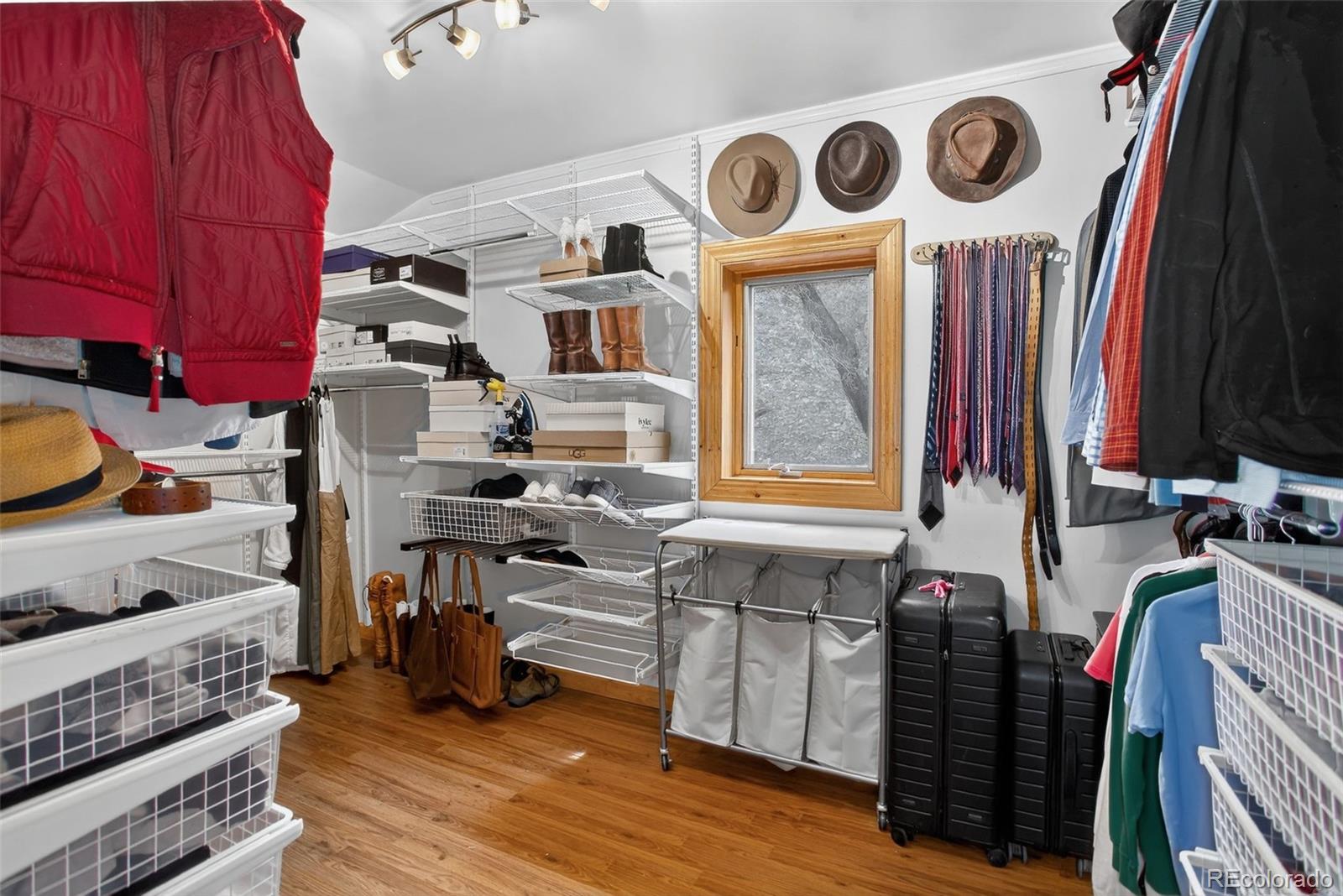 31911 Warrens Road Golden, CO 80403 - Photo 17 of 42 a view of walk in closet with clothes and shoes