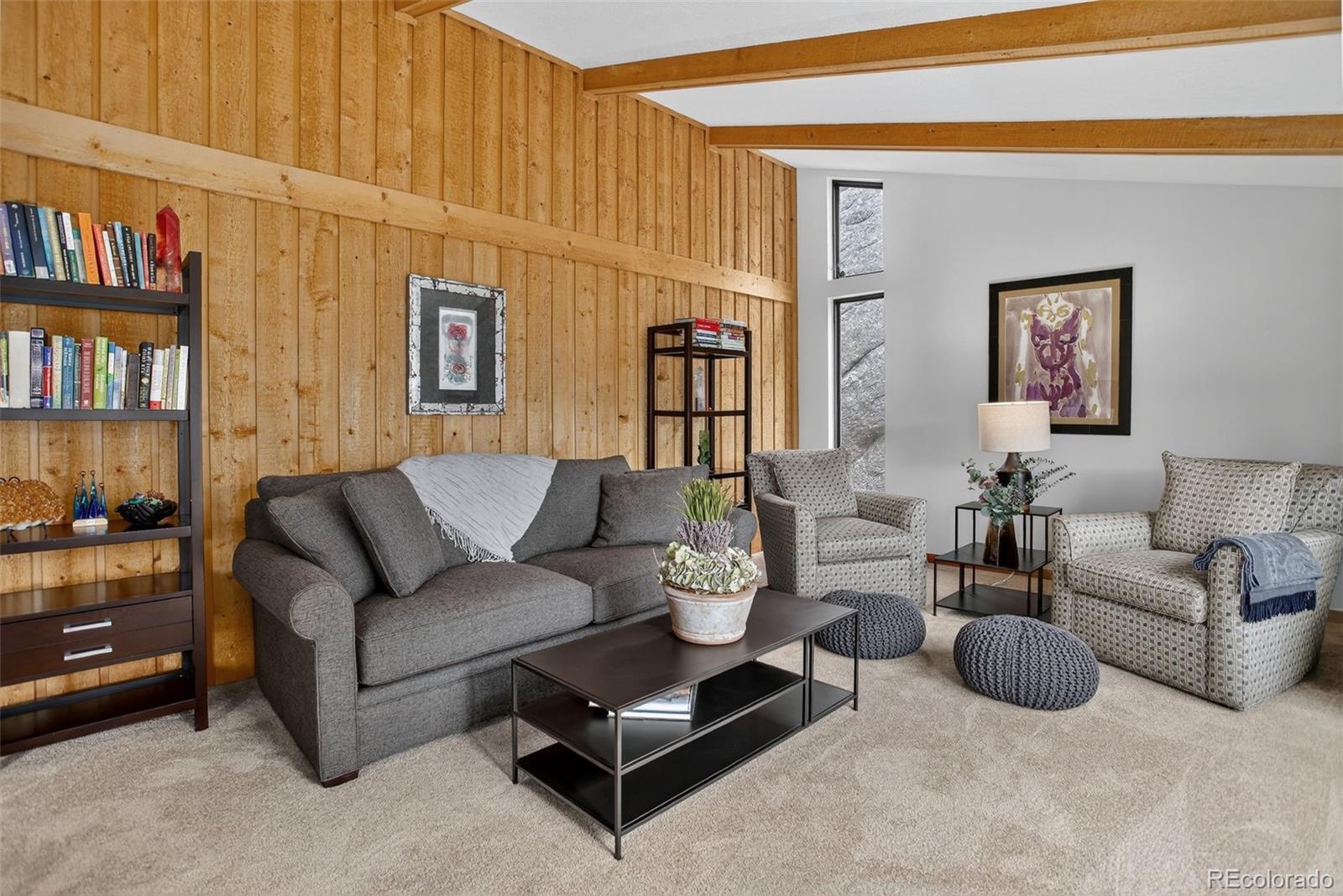 31911 Warrens Road Golden, CO 80403 - Photo 2 of 42 a living room with furniture and a book shelf
