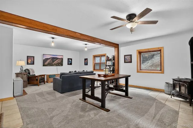 a room with a table chairs and a lamp