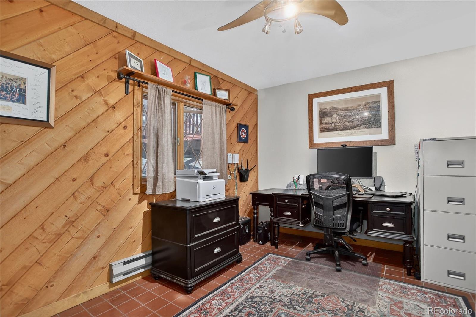 31911 Warrens Road Golden, CO 80403 - Photo 22 of 42 a room with a table chairs and a lamp