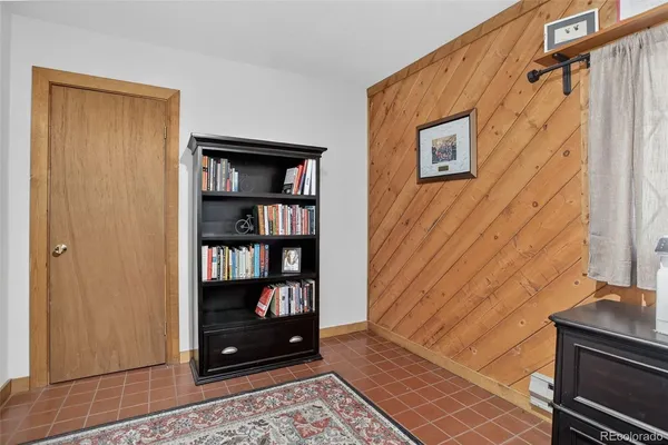a bedroom with a large bed and a large window