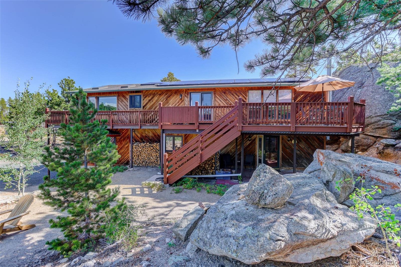 31911 Warrens Road Golden, CO 80403 - Photo 27 of 42 a view of a house with a yard balcony and furniture