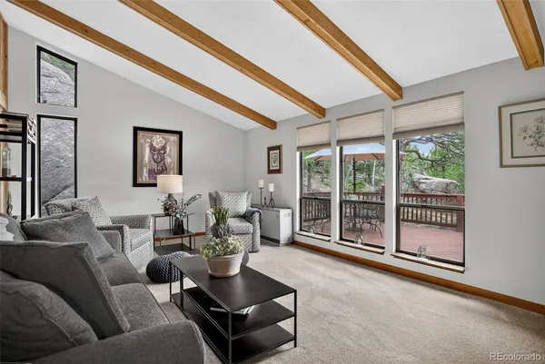 a living room with furniture and a floor to ceiling window