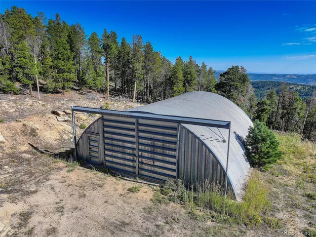 an aerial view of a house with a yard and trees