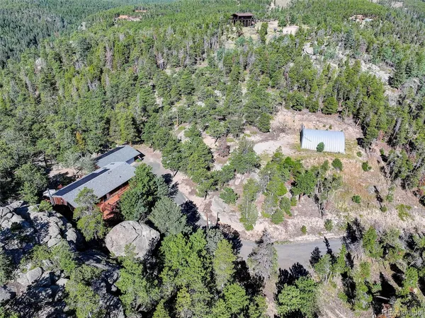 an aerial view of a house with a yard