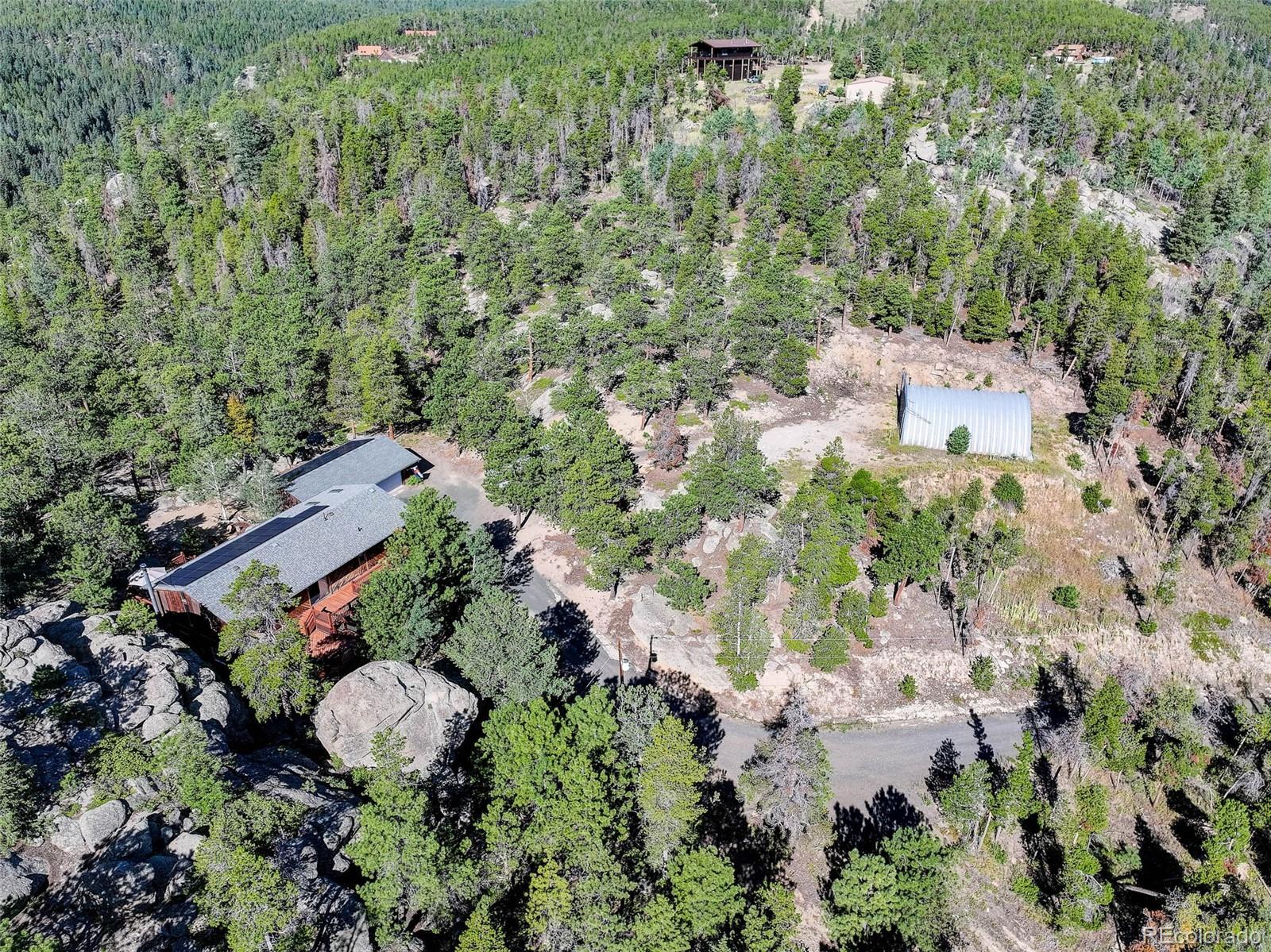 31911 Warrens Road Golden, CO 80403 - Photo 32 of 42 an aerial view of a house with a yard and trees