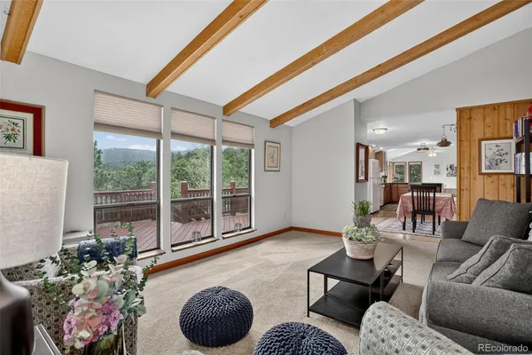 a living room with furniture and a floor to ceiling window