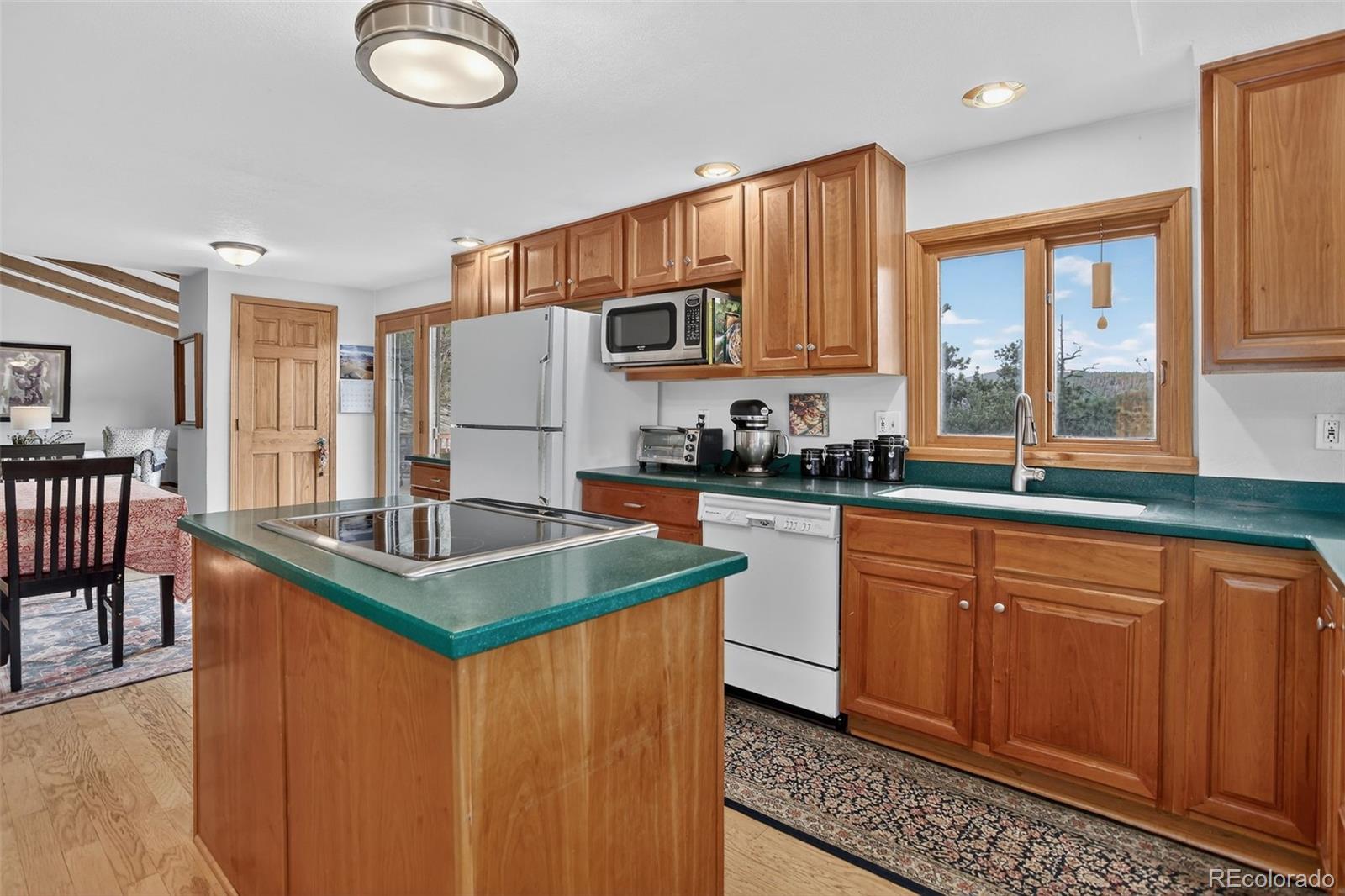 31911 Warrens Road Golden, CO 80403 - Photo 9 of 42 a kitchen with stainless steel appliances granite countertop a sink stove and refrigerator