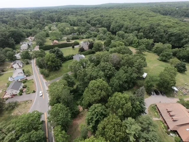 an aerial view of a house with yard