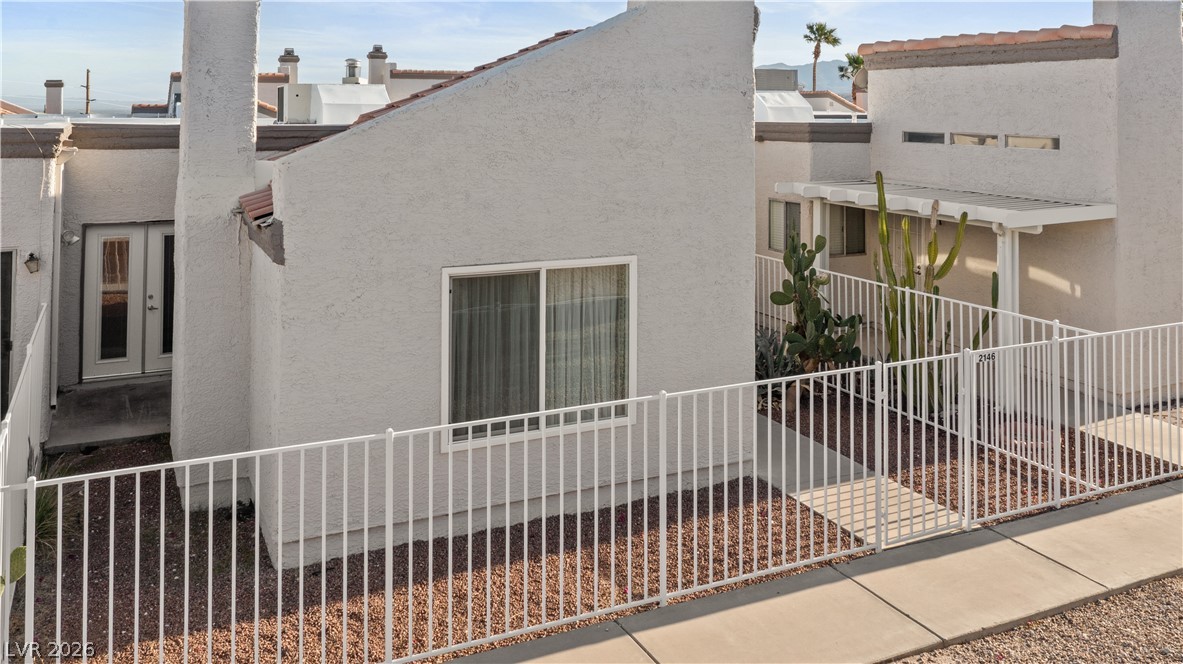 2146 High Dunes Lane Laughlin, NV 89029 - Photo 49 of 64 View of home's exterior with stucco siding and fence