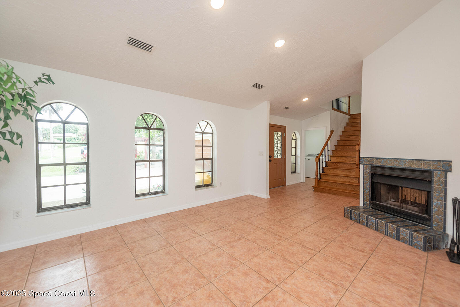 6 Point View Place Cocoa, FL 32926 - Photo 11 of 27 an empty room with windows and fireplace