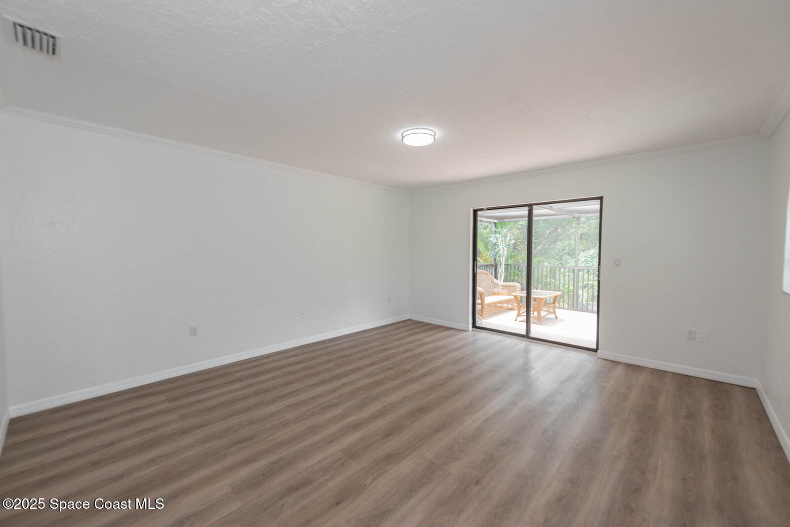 6 Point View Place Cocoa, FL 32926 - Photo 13 of 27 a view of an empty room with wooden floor and a window