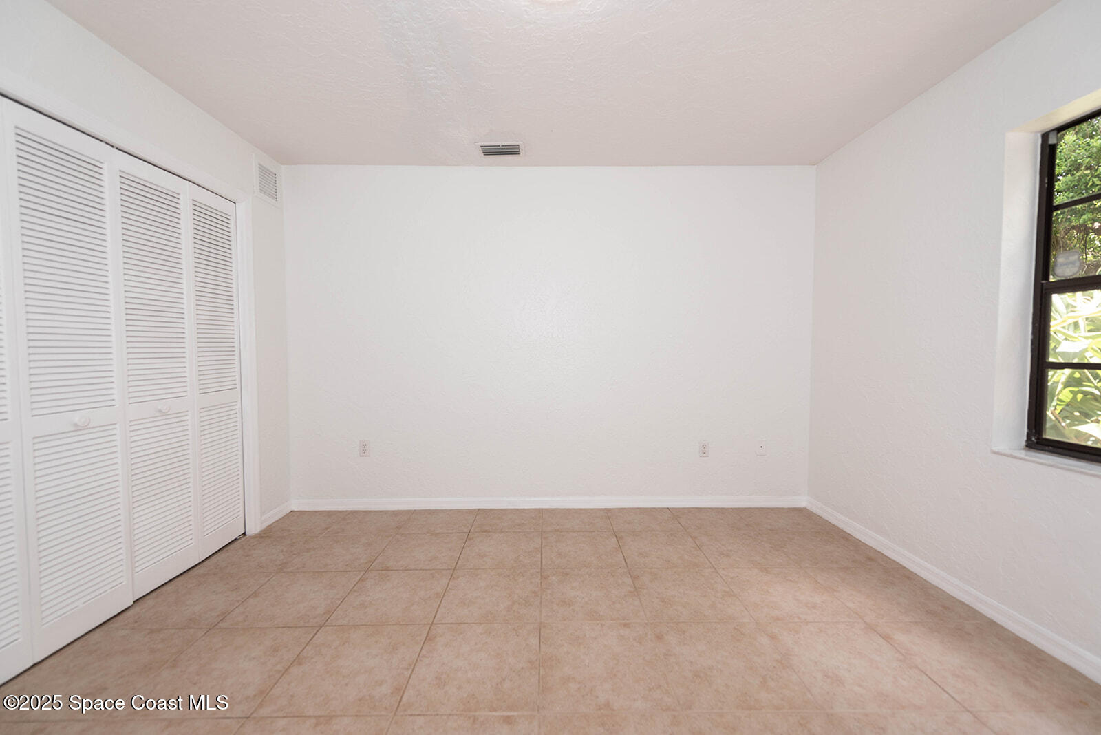 6 Point View Place Cocoa, FL 32926 - Photo 17 of 27 an empty room with a window