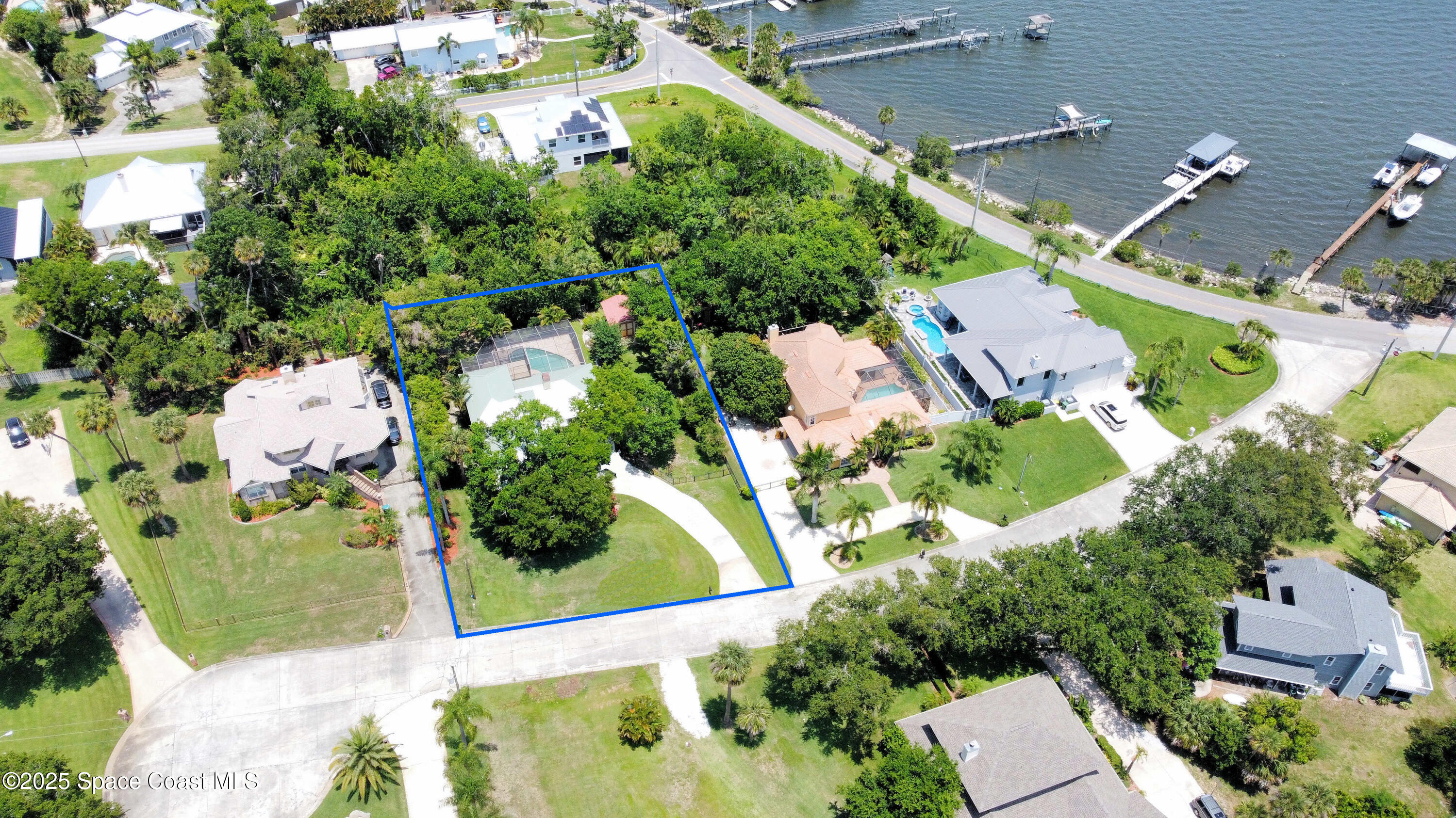 6 Point View Place Cocoa, FL 32926 - Photo 2 of 27 an aerial view of a house with a yard and lake view