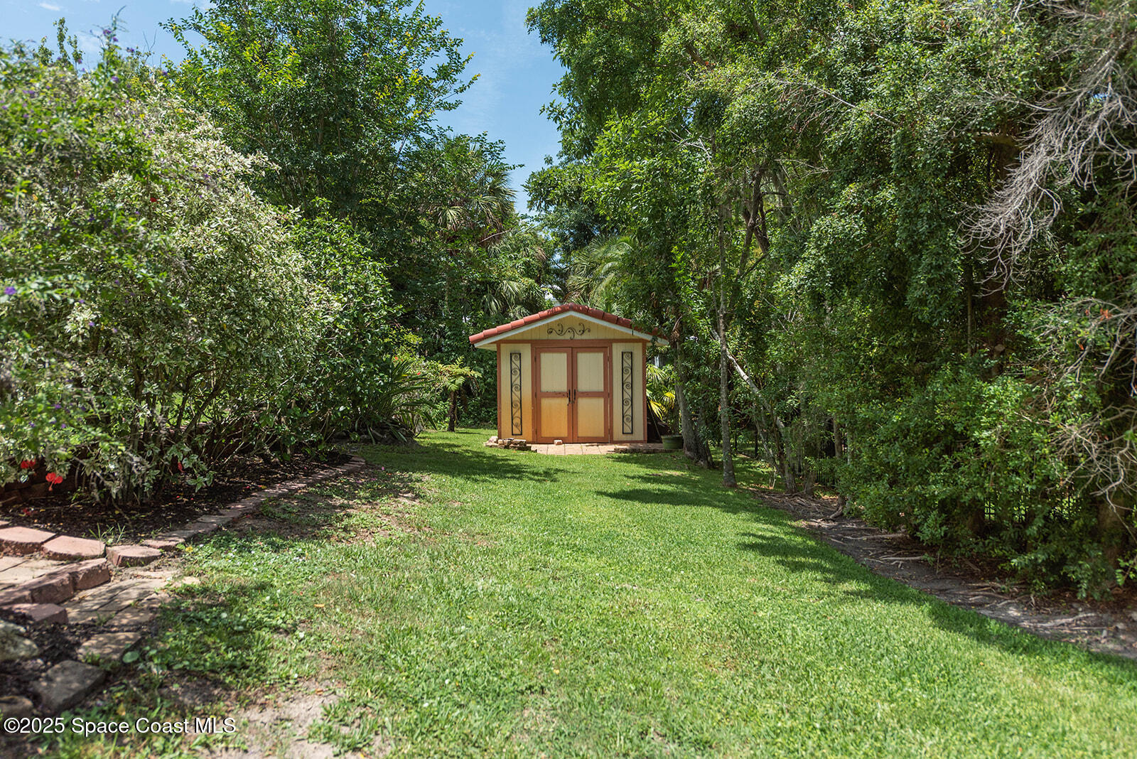6 Point View Place Cocoa, FL 32926 - Photo 23 of 27 a backyard of a house with trees and entertaining space